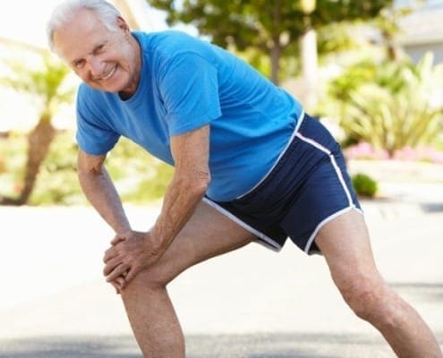 Elderly man exercising and stretching