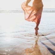 woman dancing on beach showing only legs