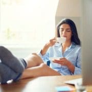 woman drinking coffee with elevated legs