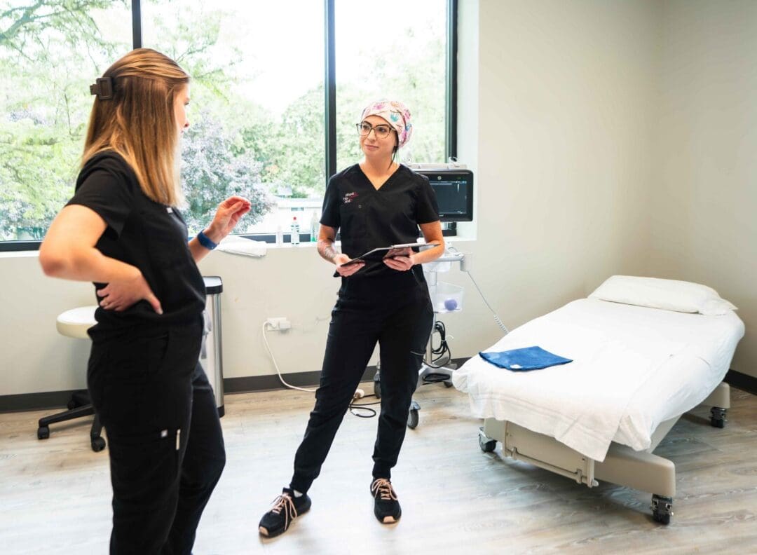 Two vein specialists in a patient room